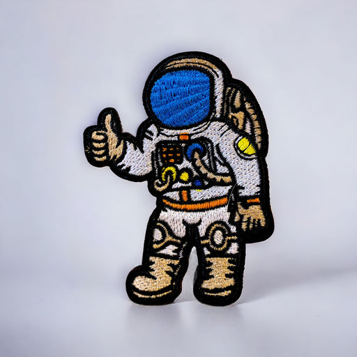 Astronaut embroidered iron-on patch with a full space suit and blue helmet.