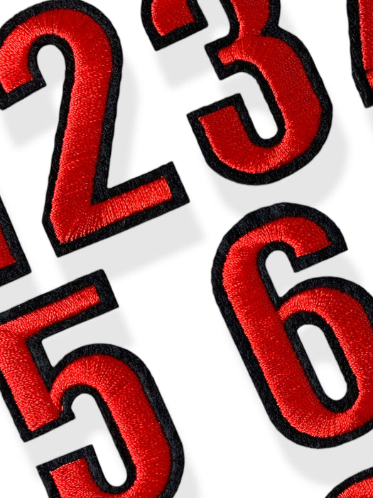 Close up of 5cm red embroidered iron-on patch numbers with a contrasting black felt border