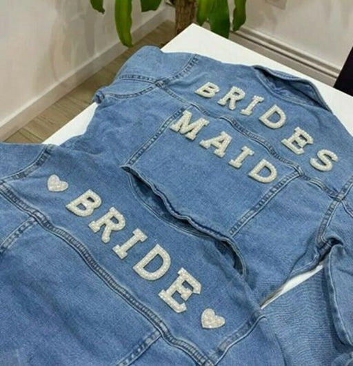 White pearl silver rhinestone iron on patch letters with hearts on denim jackets spelling Bride and Bridesmaid